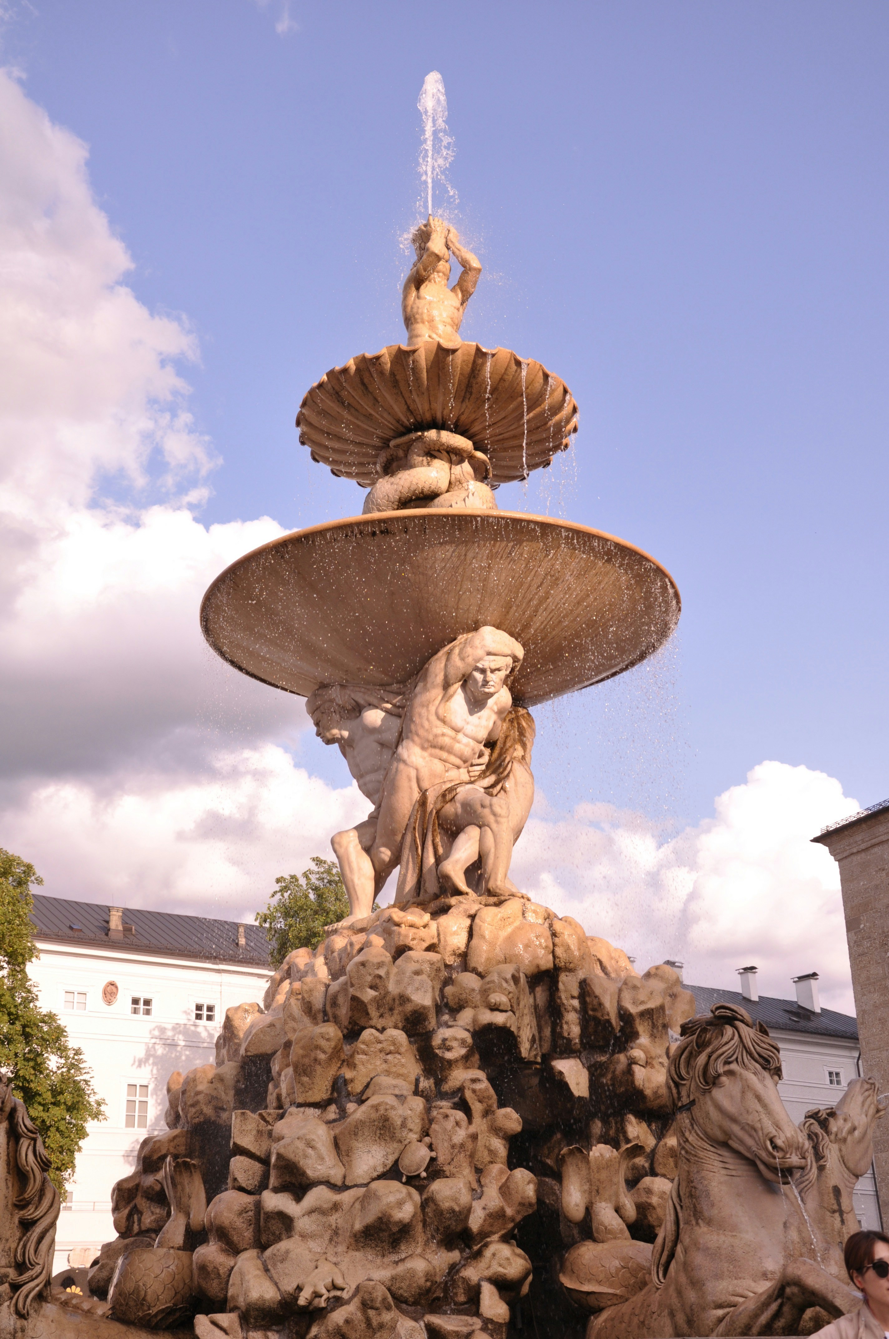 gray concrete outdoor fountain under cloudy sky during daytime