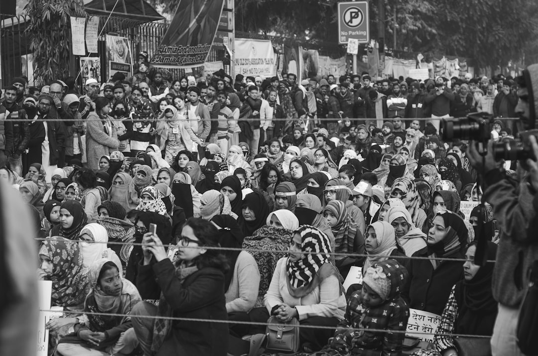 grayscale photo of people in a street