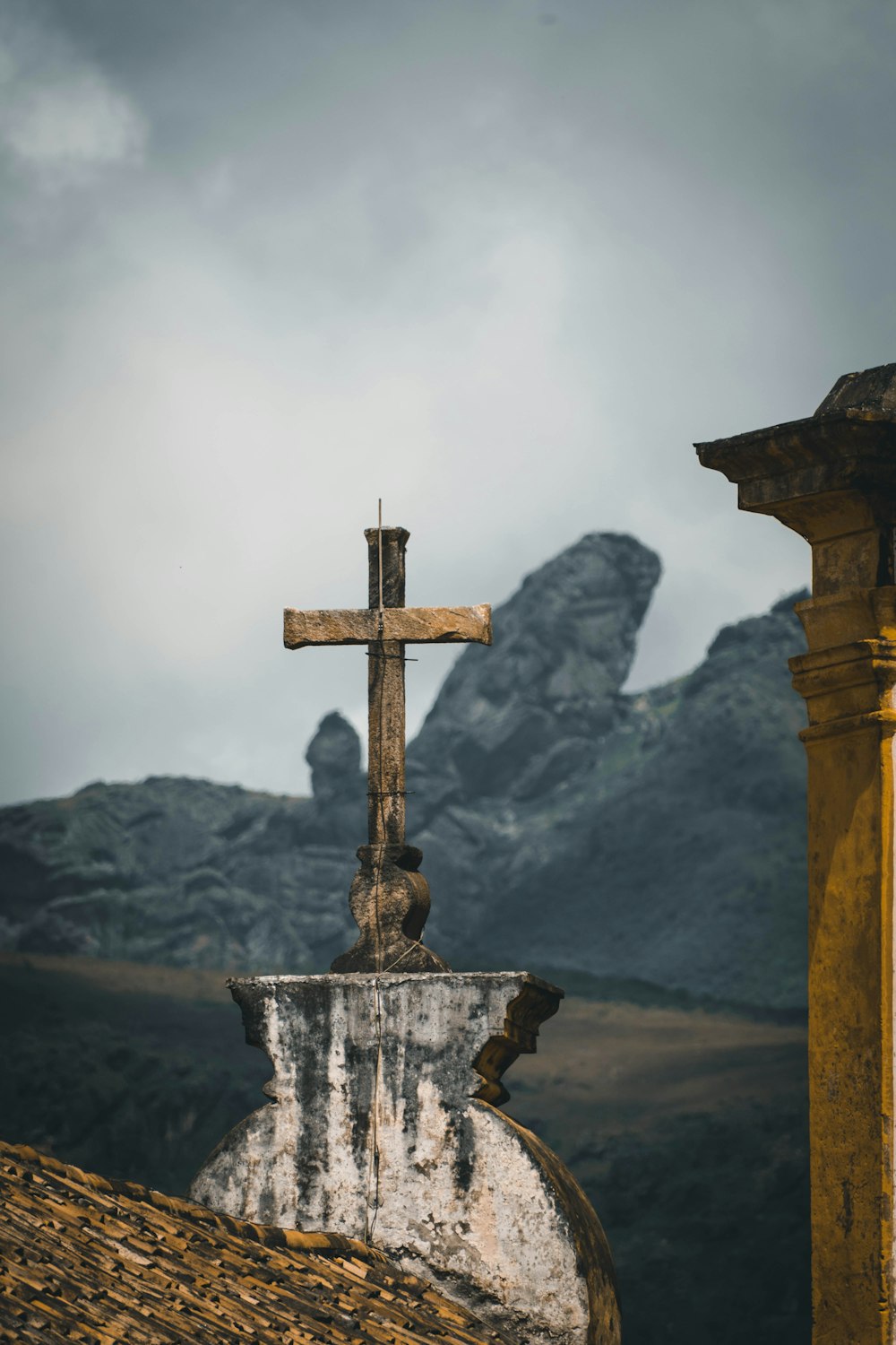 brown cross on gray concrete stand