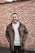 man in brown leather jacket smiling