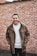 man in brown leather jacket smiling