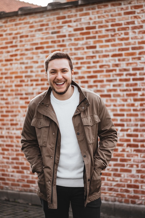 man in brown leather jacket smiling