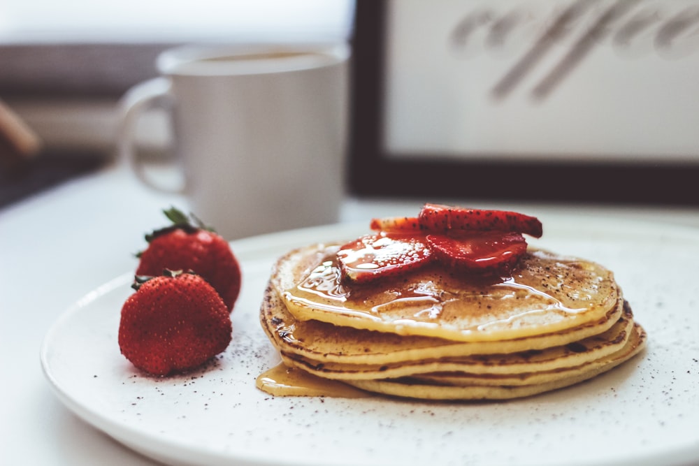 waffle with strawberry on white ceramic plate