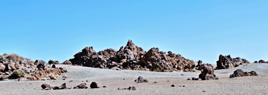 gray rocks on gray sand during daytime in Tenerife Spain