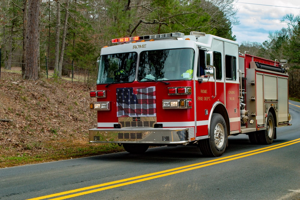 red and white fire truck on road during daytime