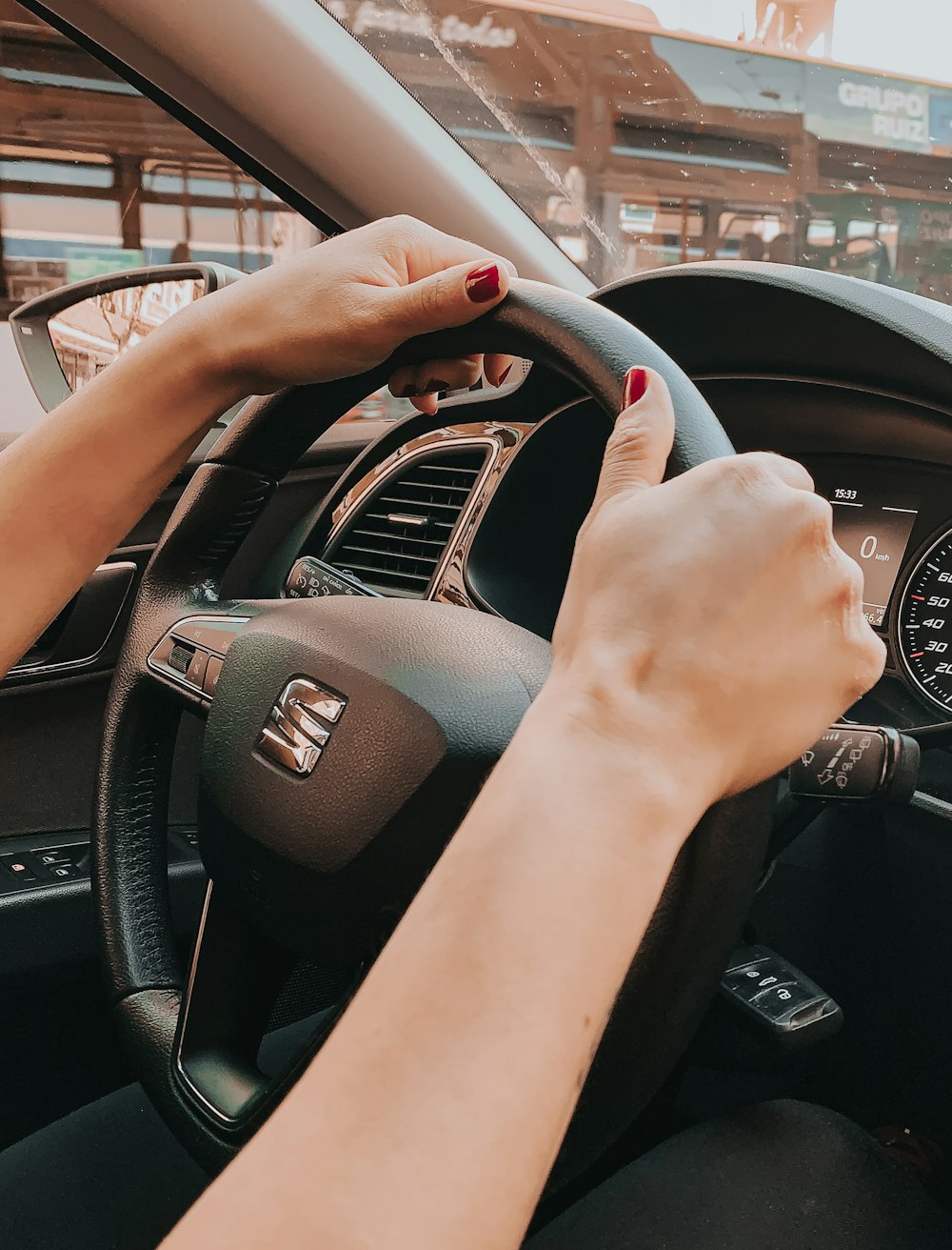 person holding black honda steering wheel