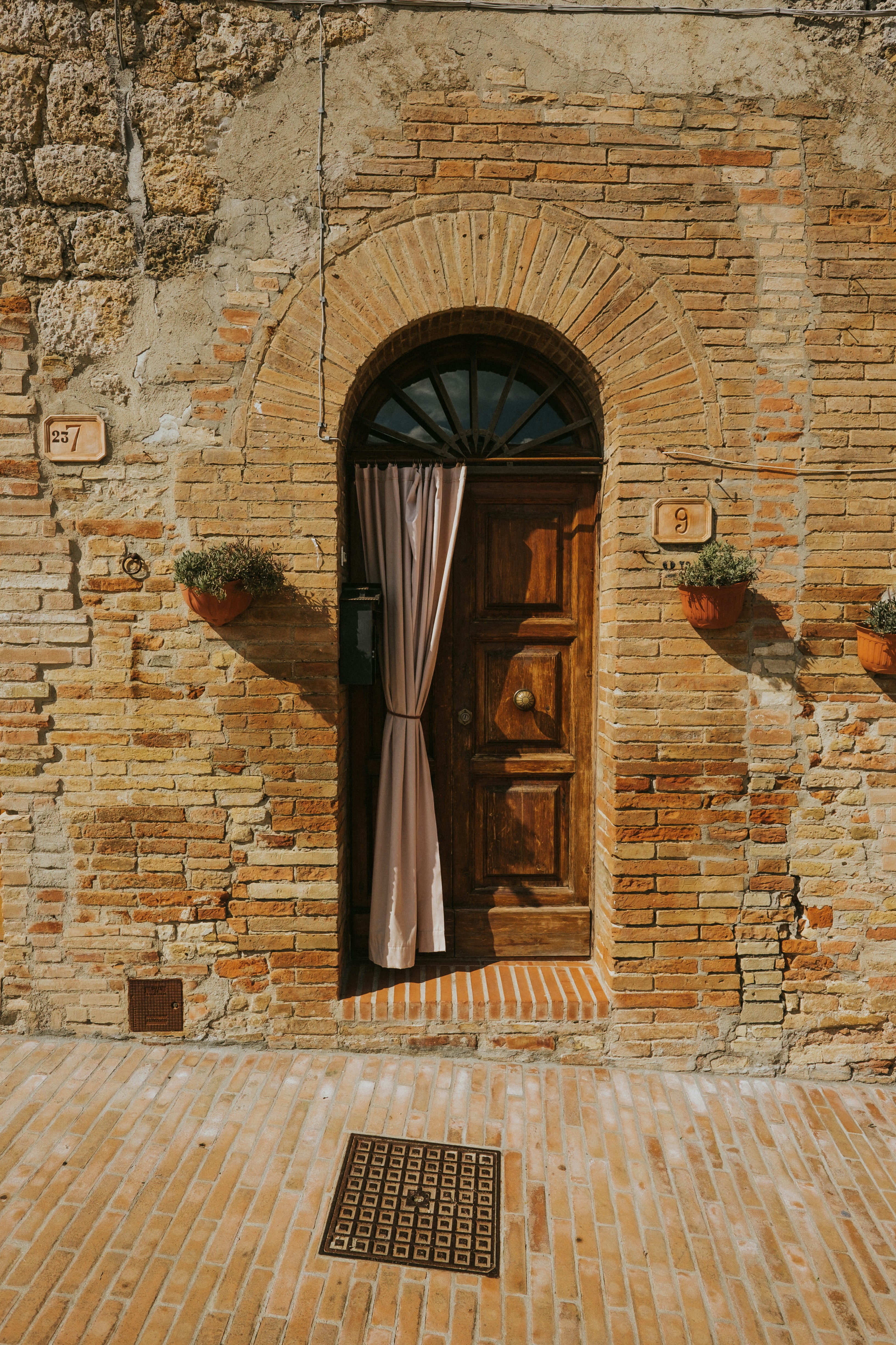 brown wooden door on brown brick wall