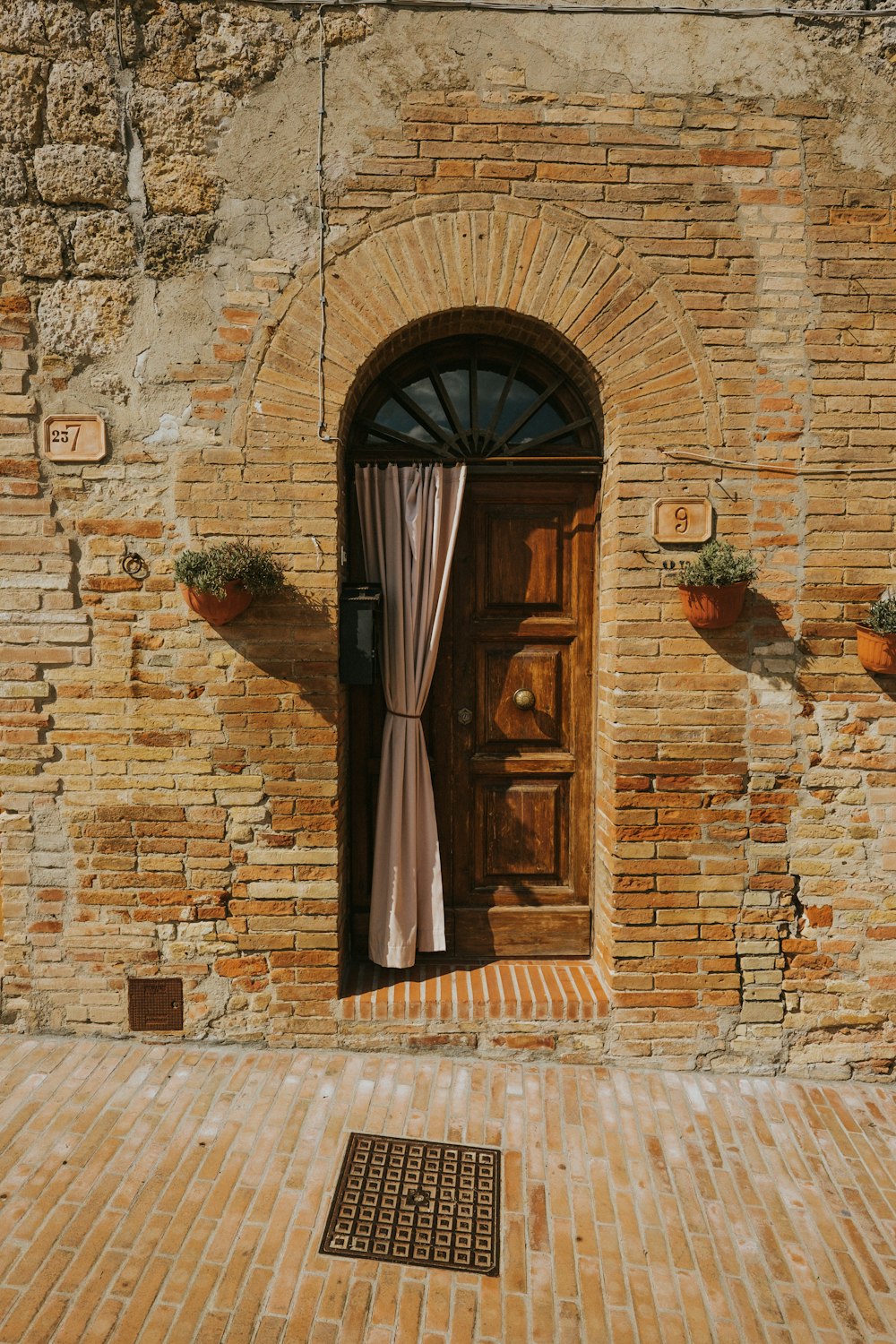 brown wooden door on brown brick wall