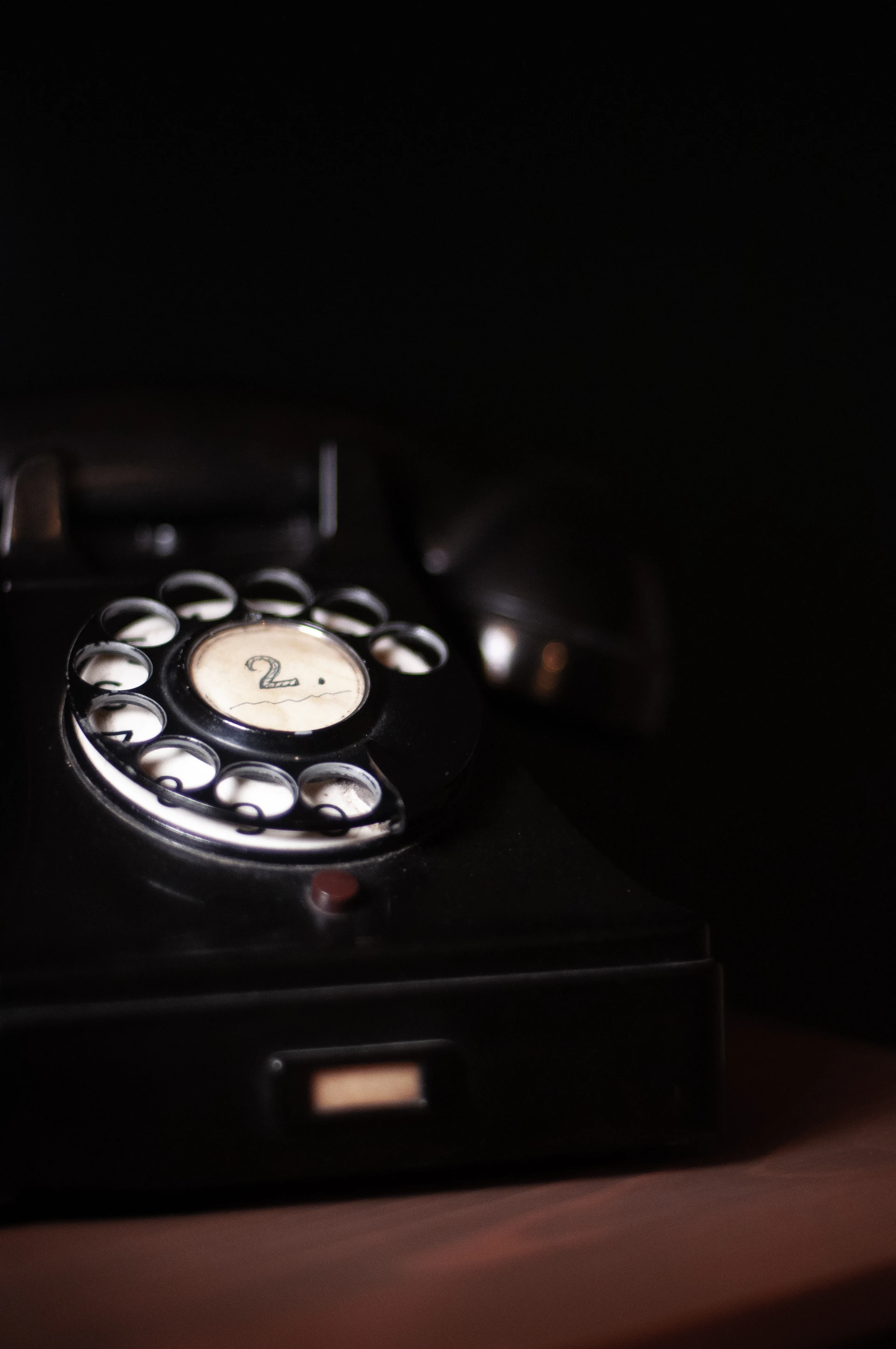 black rotary phone on black textile