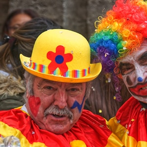 man in yellow orange and blue wig