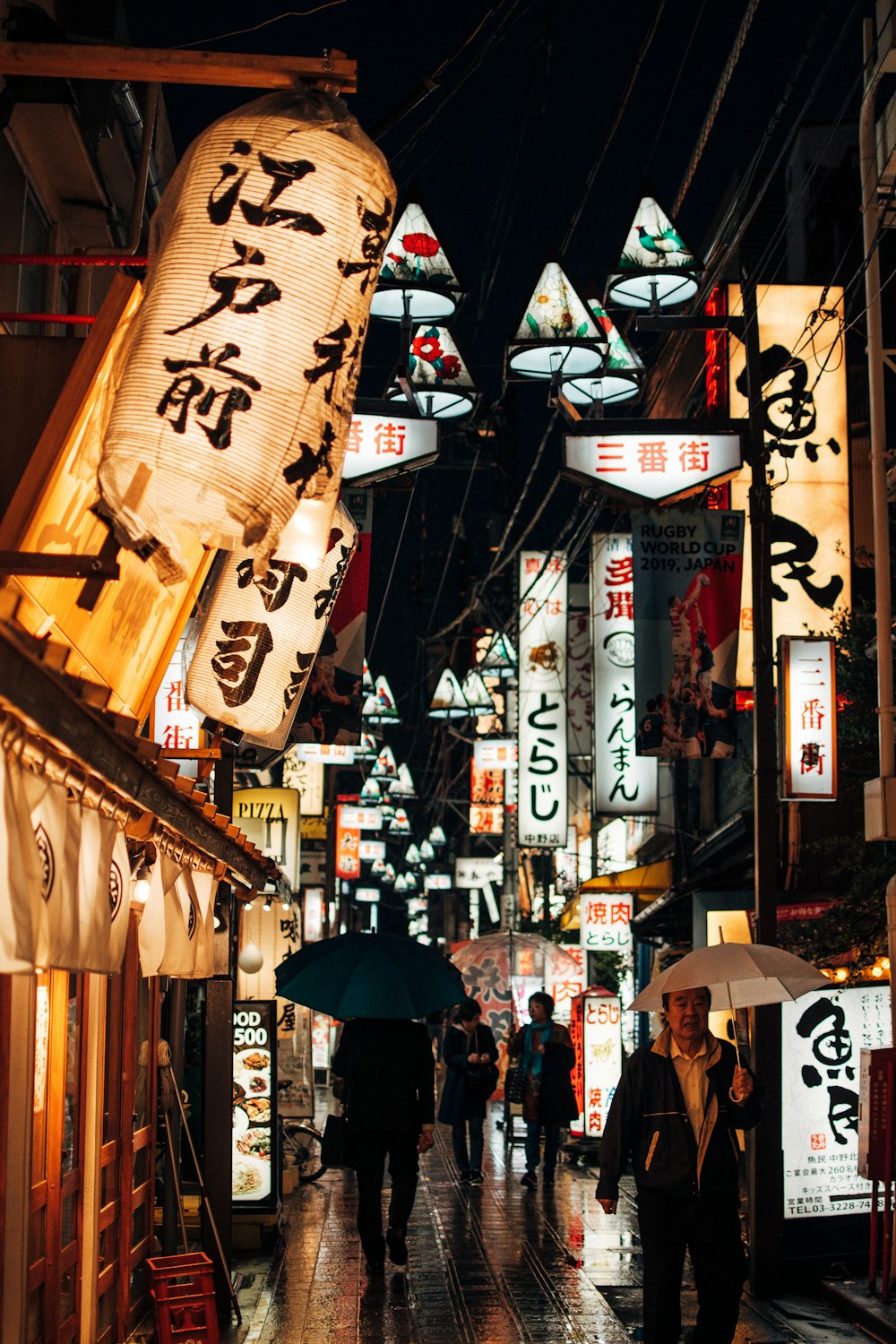 people walking on street during night time