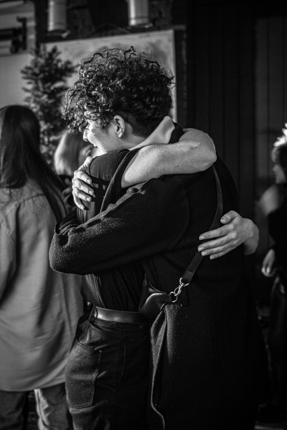 man in black jacket kissing woman in black shirt