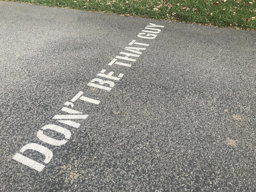 white and black pedestrian line on gray asphalt road