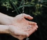 water drop on persons hand