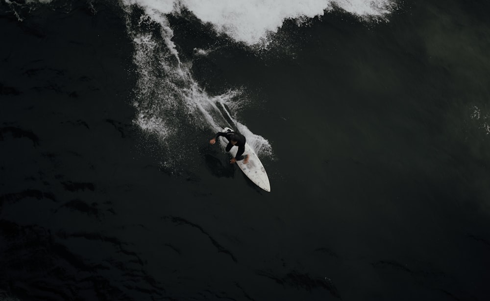 person surfing on sea waves during daytime