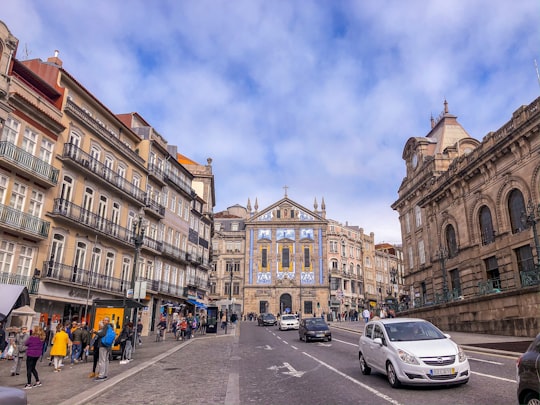 people walking on street near brown concrete building during daytime in Igreja de Santo António dos Congregados Portugal