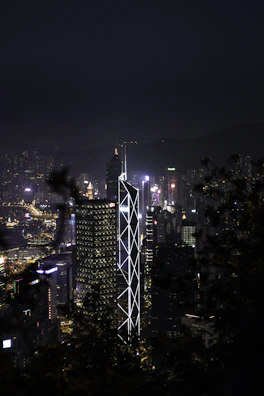 Evening city skyline backdrop with a model in qam’s layered outfit, capturing urban energy.
