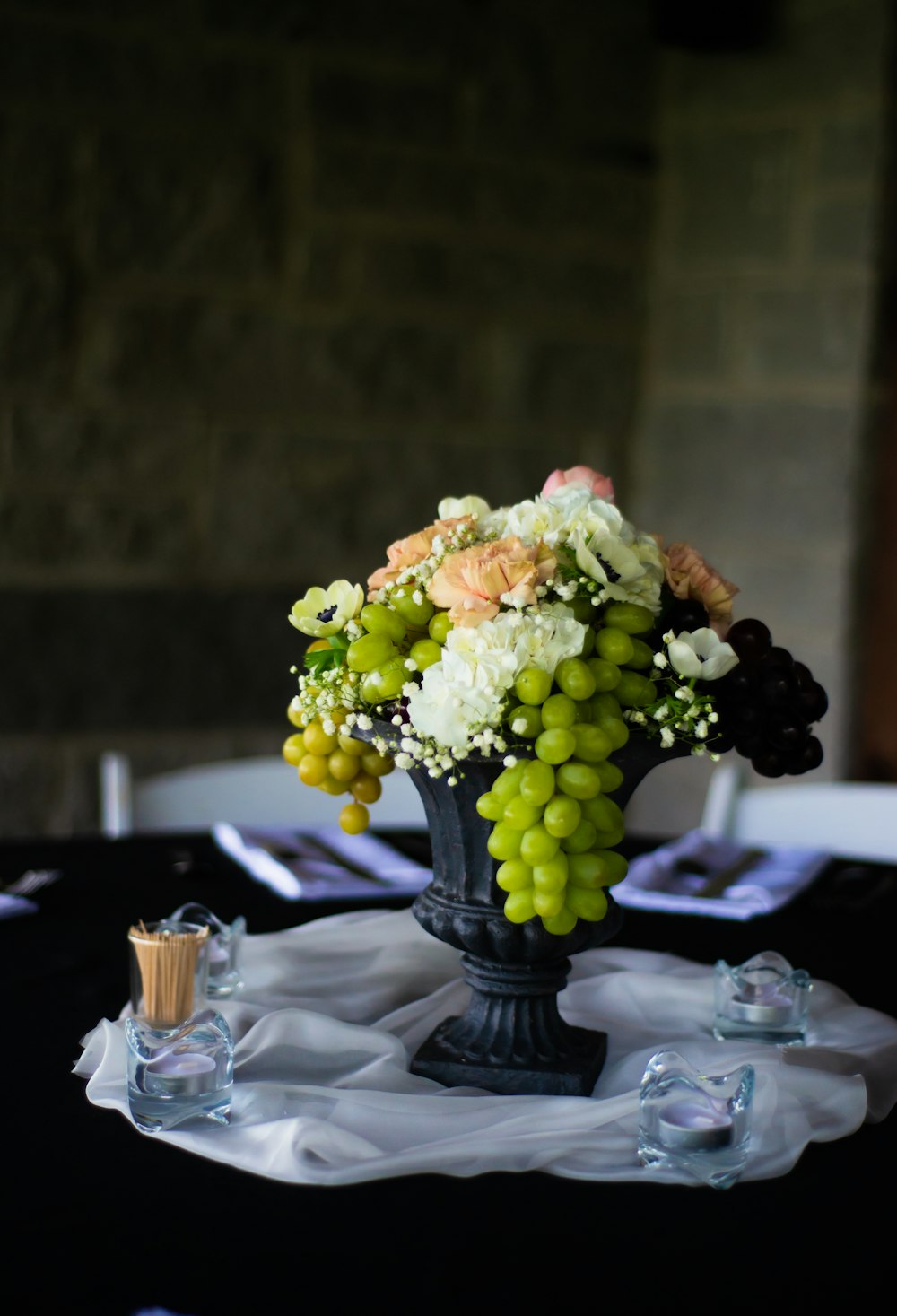 white and pink flower bouquet on black glass vase