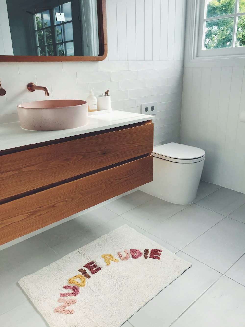 white ceramic sink beside white ceramic bathtub