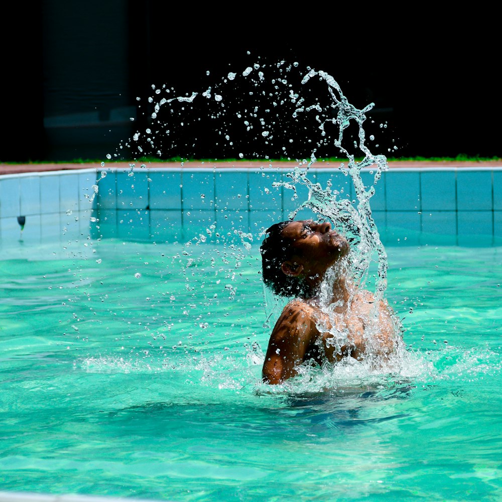 man in swimming pool during night time