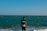 a man standing in the water at the beach