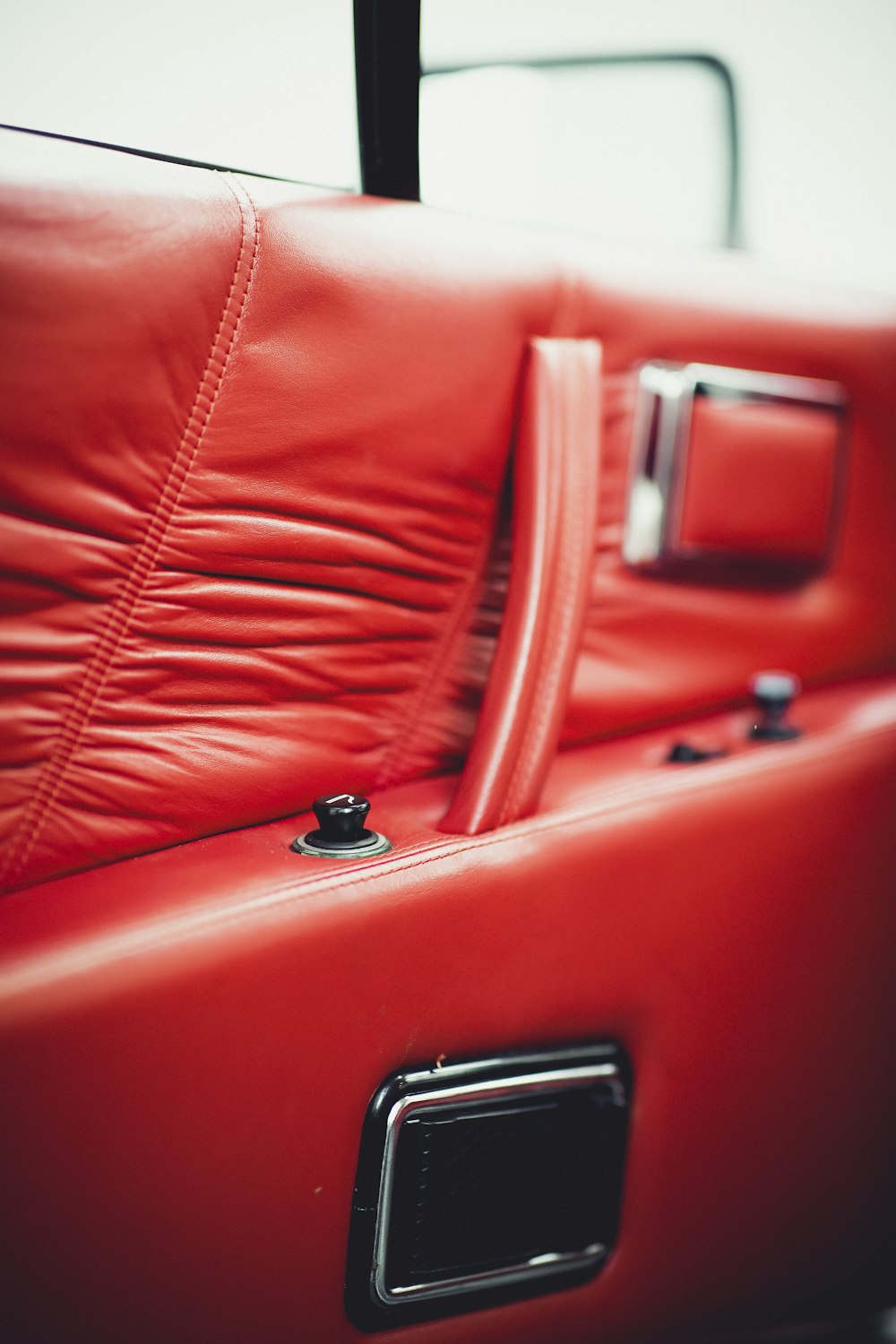 red leather car seat in close up photography