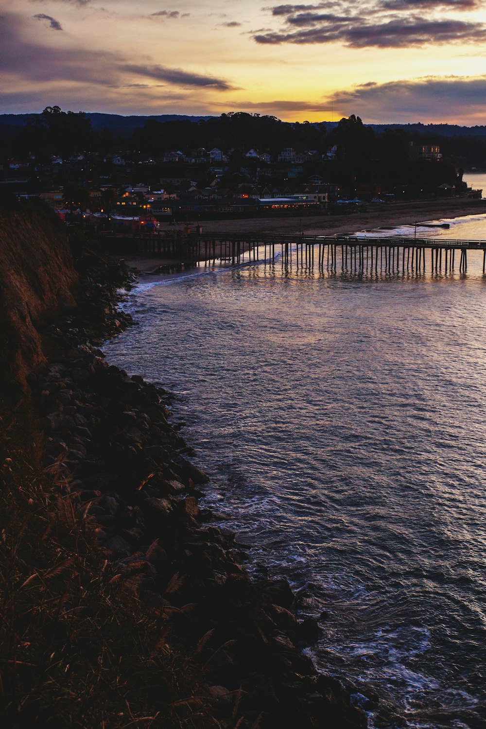 brown wooden dock on body of water during night time