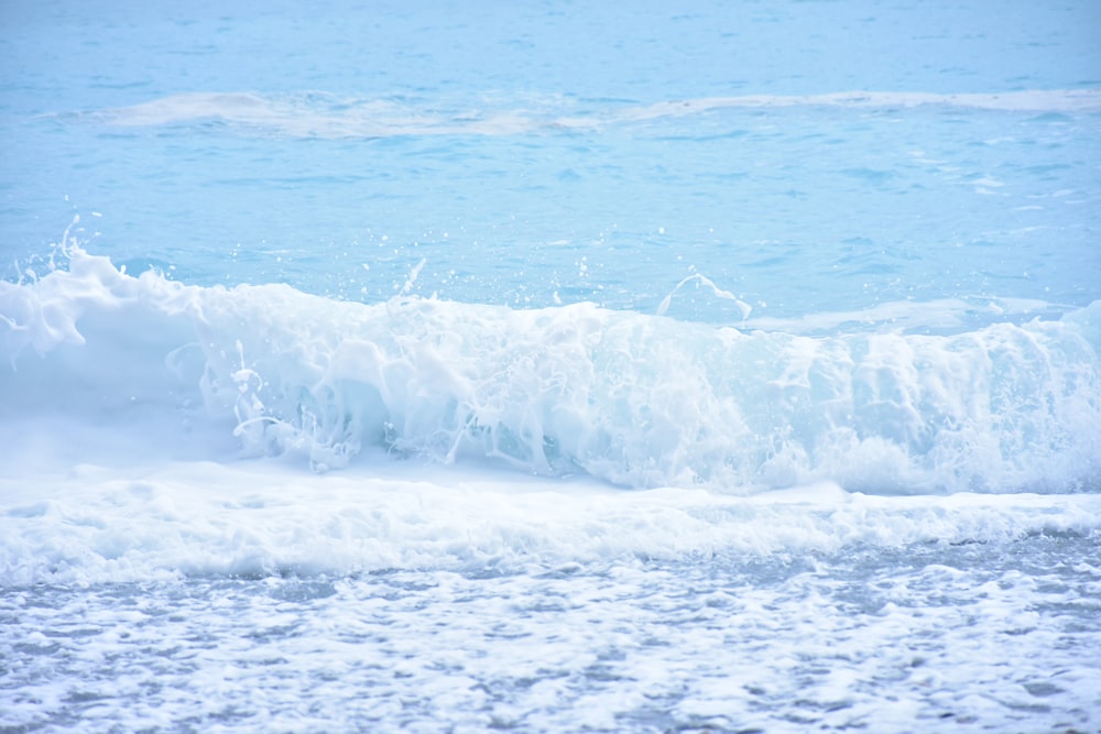 white waves on blue sea during daytime