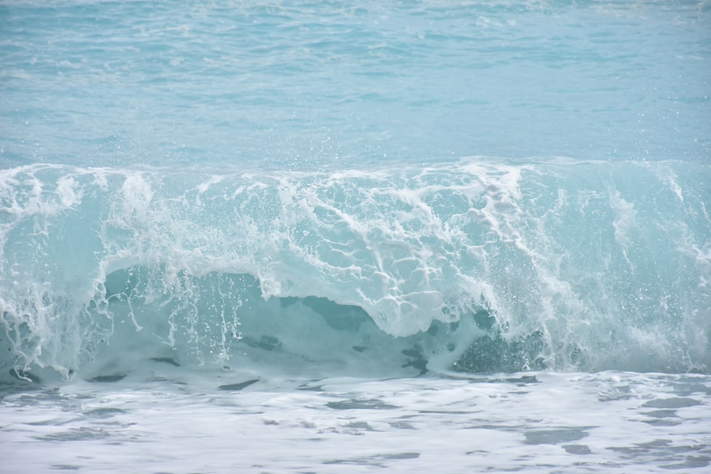 ocean waves crashing on shore during daytime