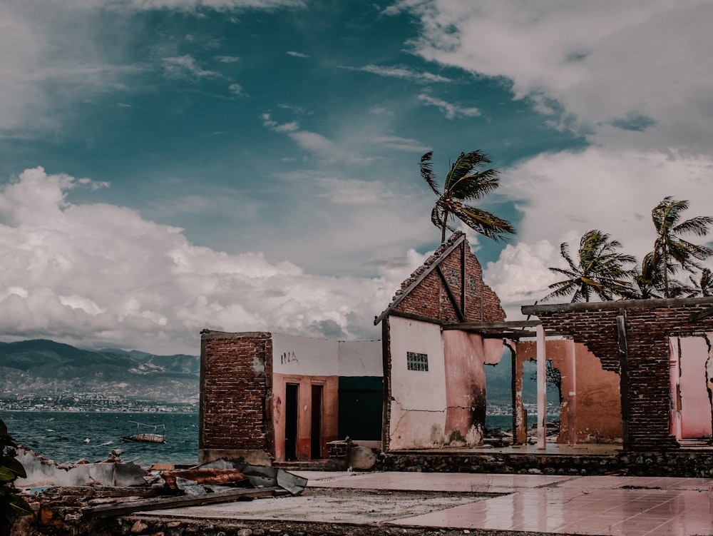 brown and white concrete building near body of water under blue sky during daytime