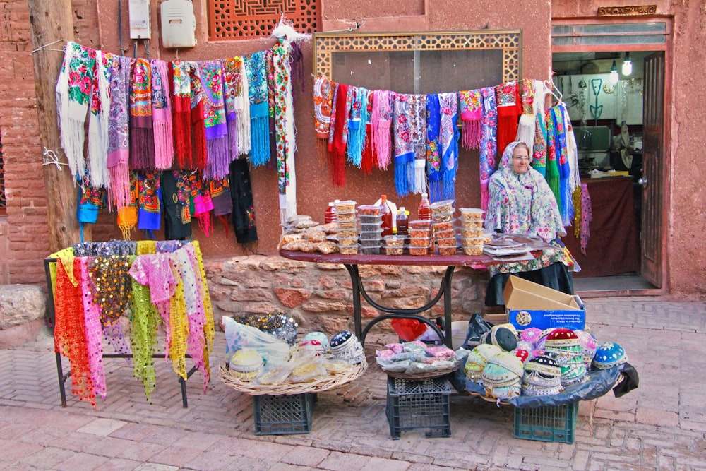 assorted clothes on brown wooden rack