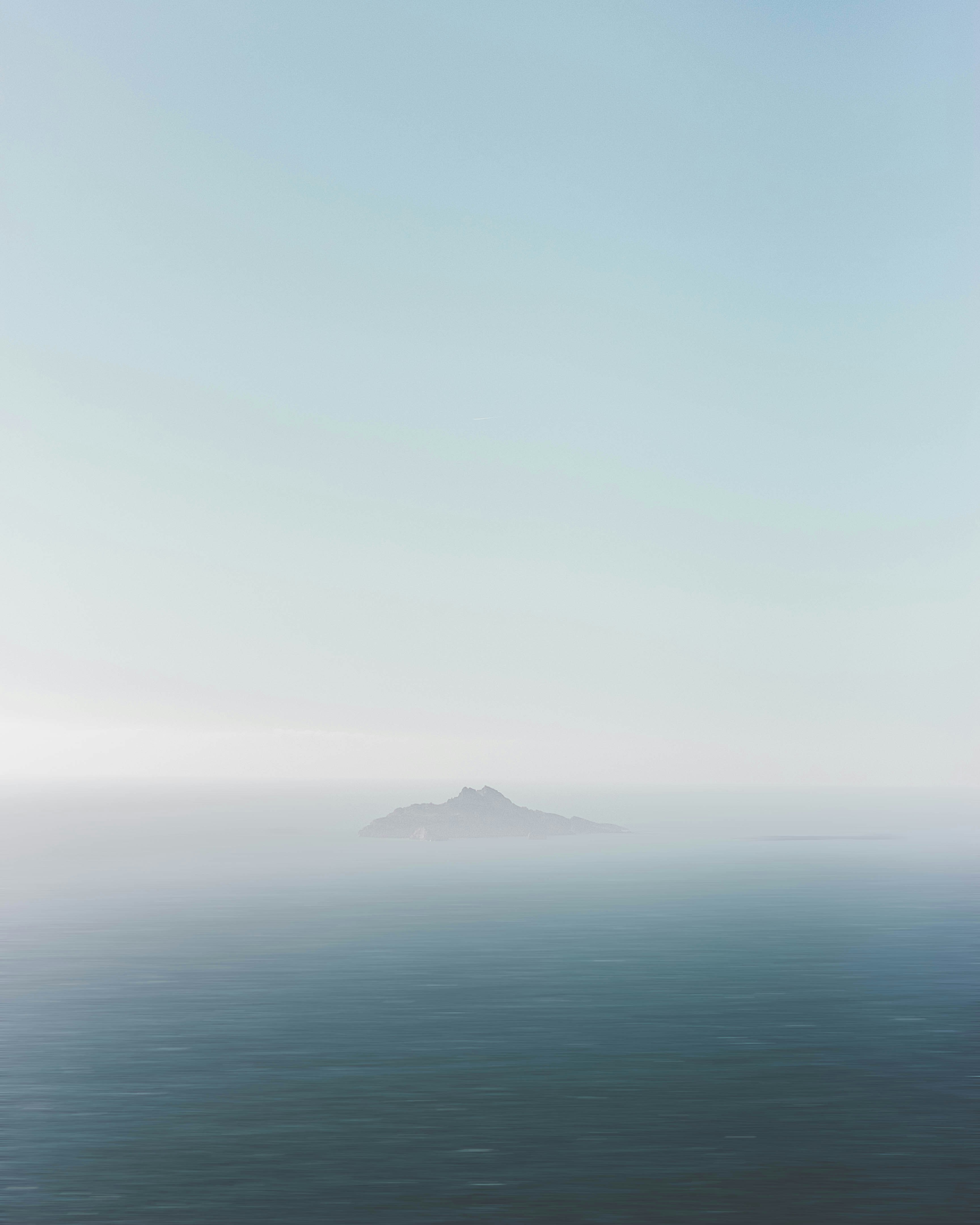 black mountain covered by white fog