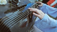 Close-up of a musician playing a traditional instrument during the celebration.