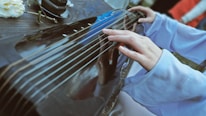 Close-up of an Albanian çifteli instrument being played.