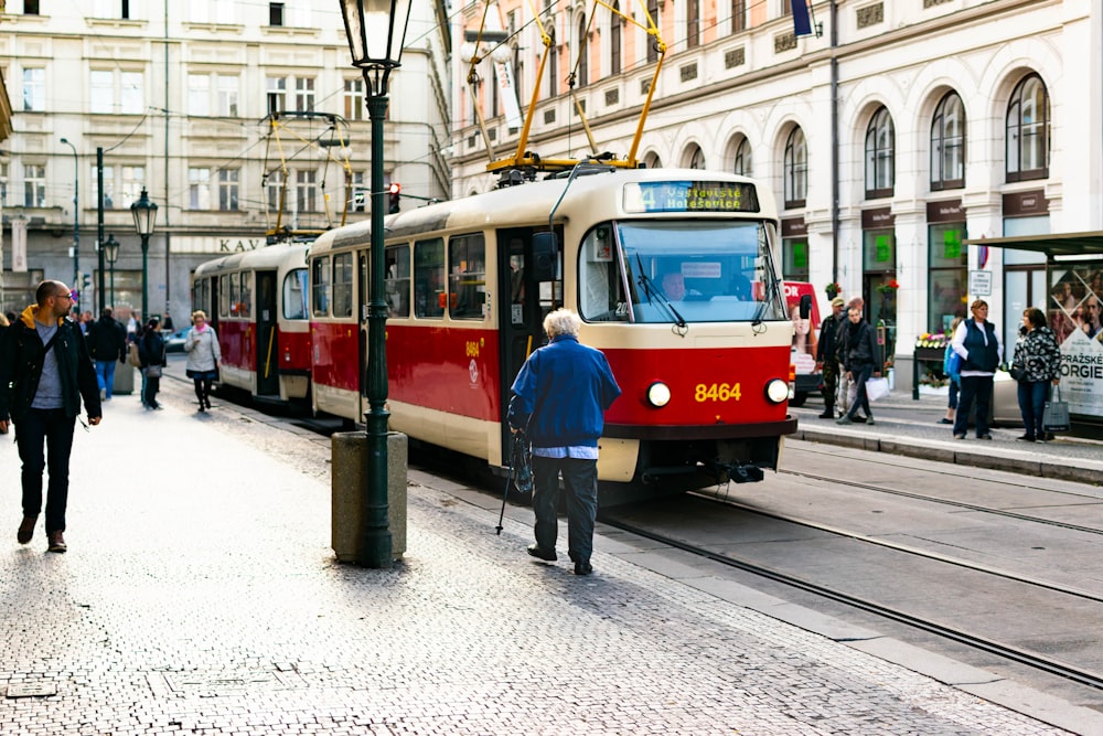 red and white tram on road during daytime