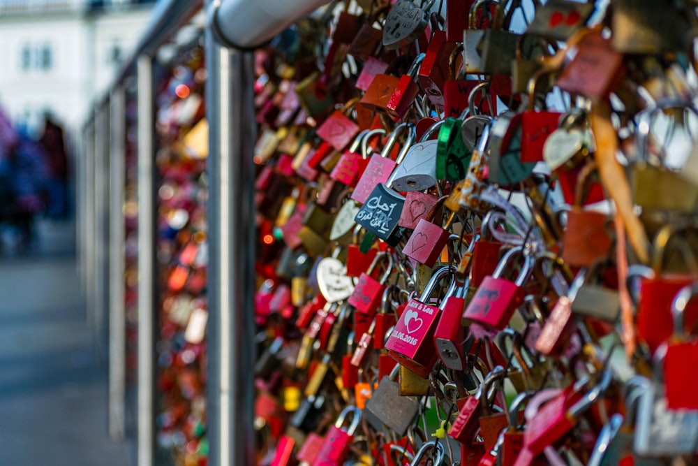 padlocks on gray steel fence during daytime