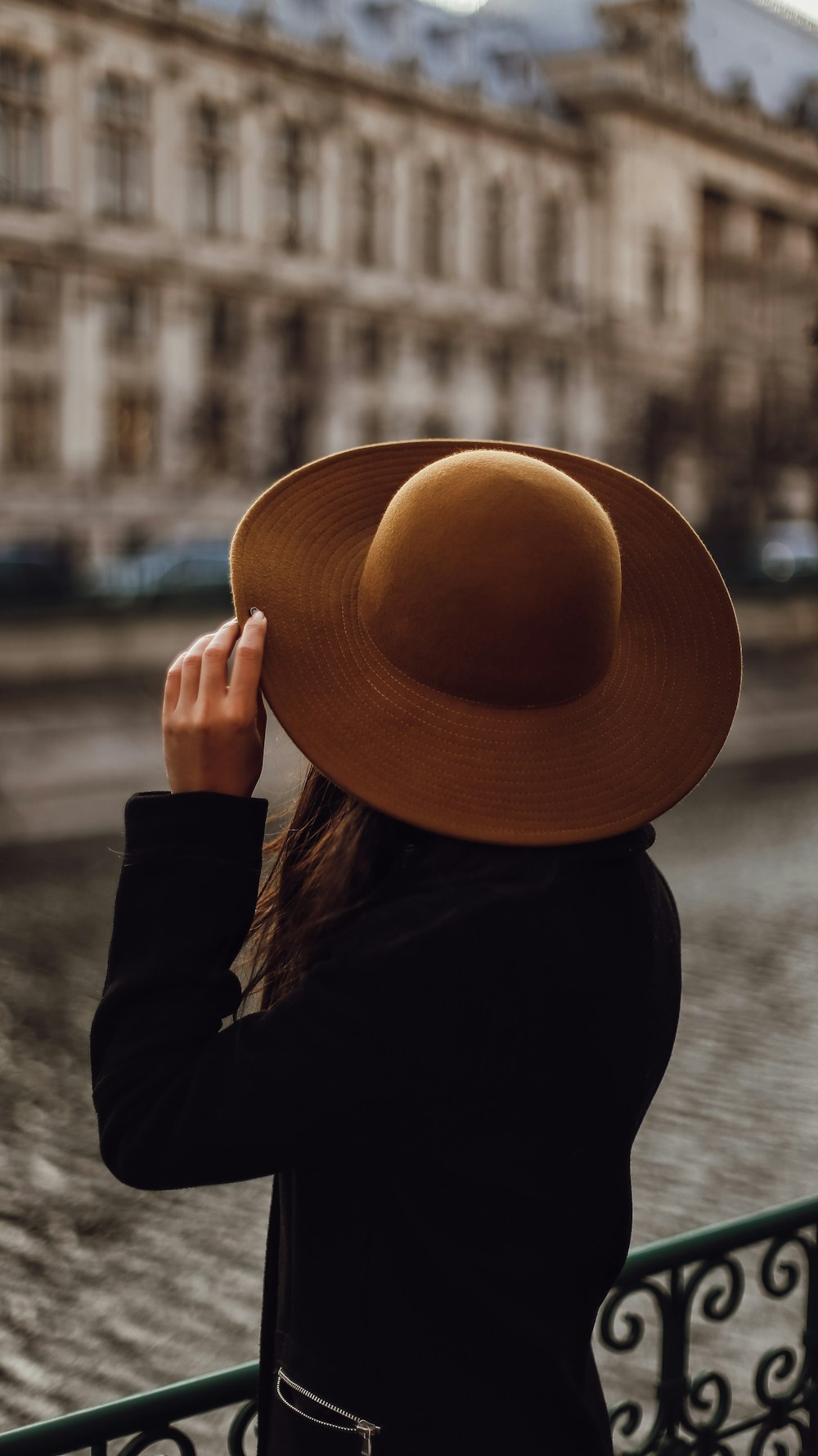 woman in black long sleeve shirt wearing brown hat