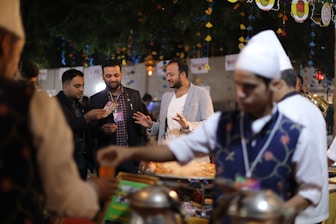 Catering team serving food at a lively outdoor event