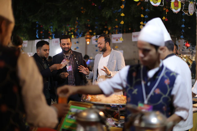 A vibrant food stall at an outdoor Irish festival with colorful arepas and smiling customers.