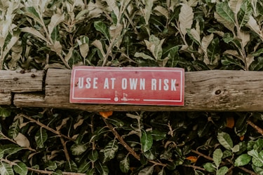 red and white wooden signage warning label to use at own risk. 