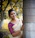 Portrait of a smiling young woman in a vibrant sari standing confidently outdoors.
