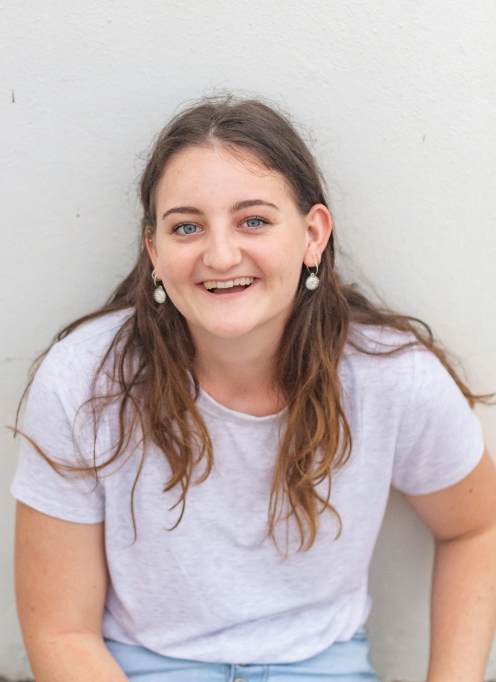 woman in white crew neck t-shirt smiling