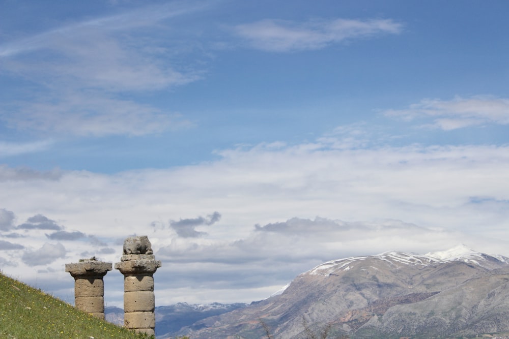 brown and white mountains under white clouds and blue sky during daytime