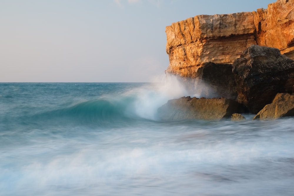 brown rock formation on sea water during daytime