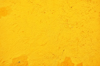 yellow concrete wall during daytime