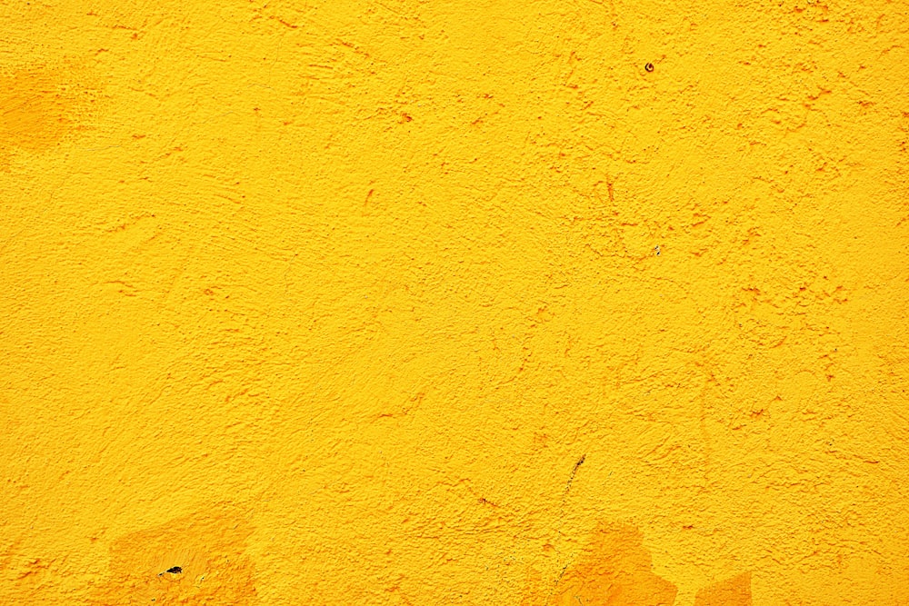 yellow concrete wall during daytime