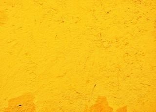 yellow concrete wall during daytime