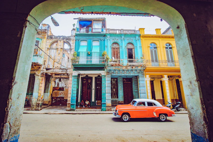 Classic car beside historic Havana architecture