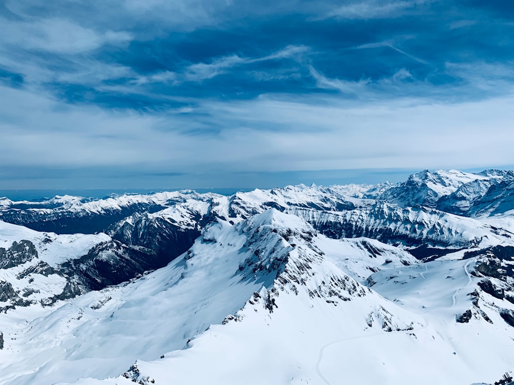 snow covered mountain under cloudy sky during daytime