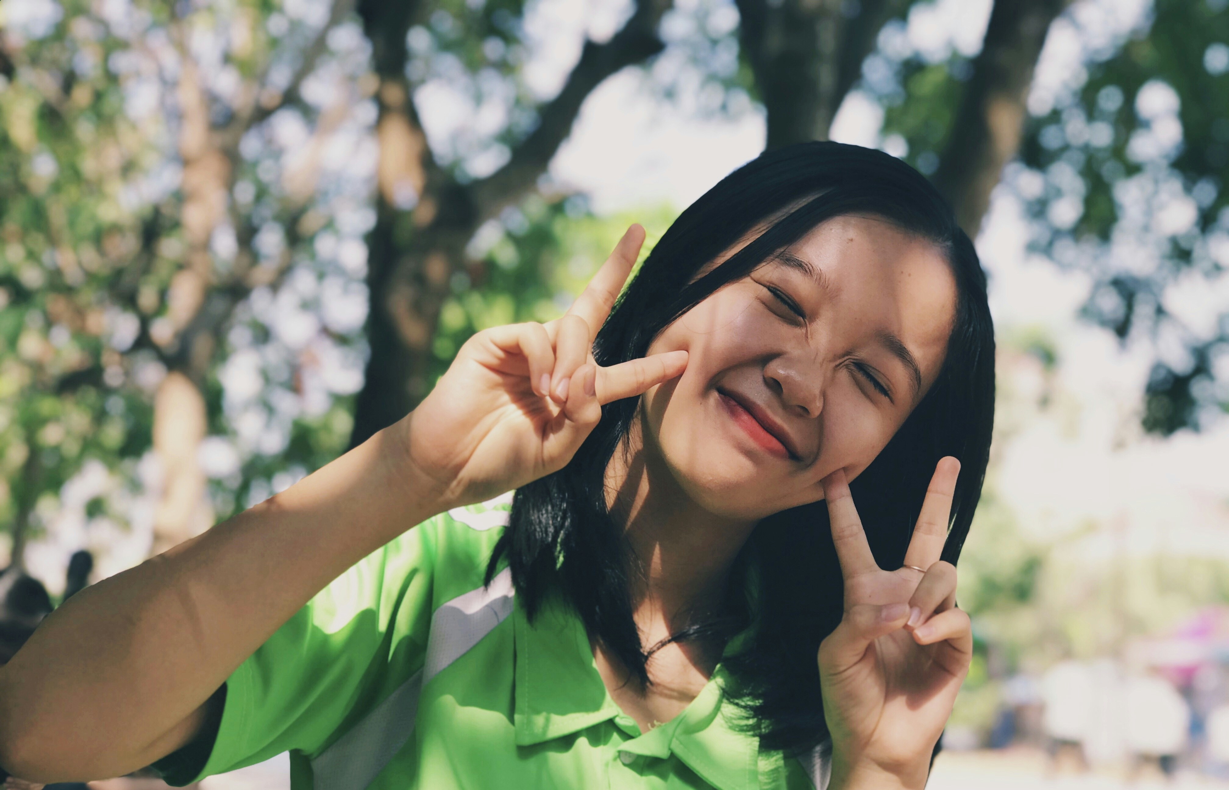 woman in green shirt smiling